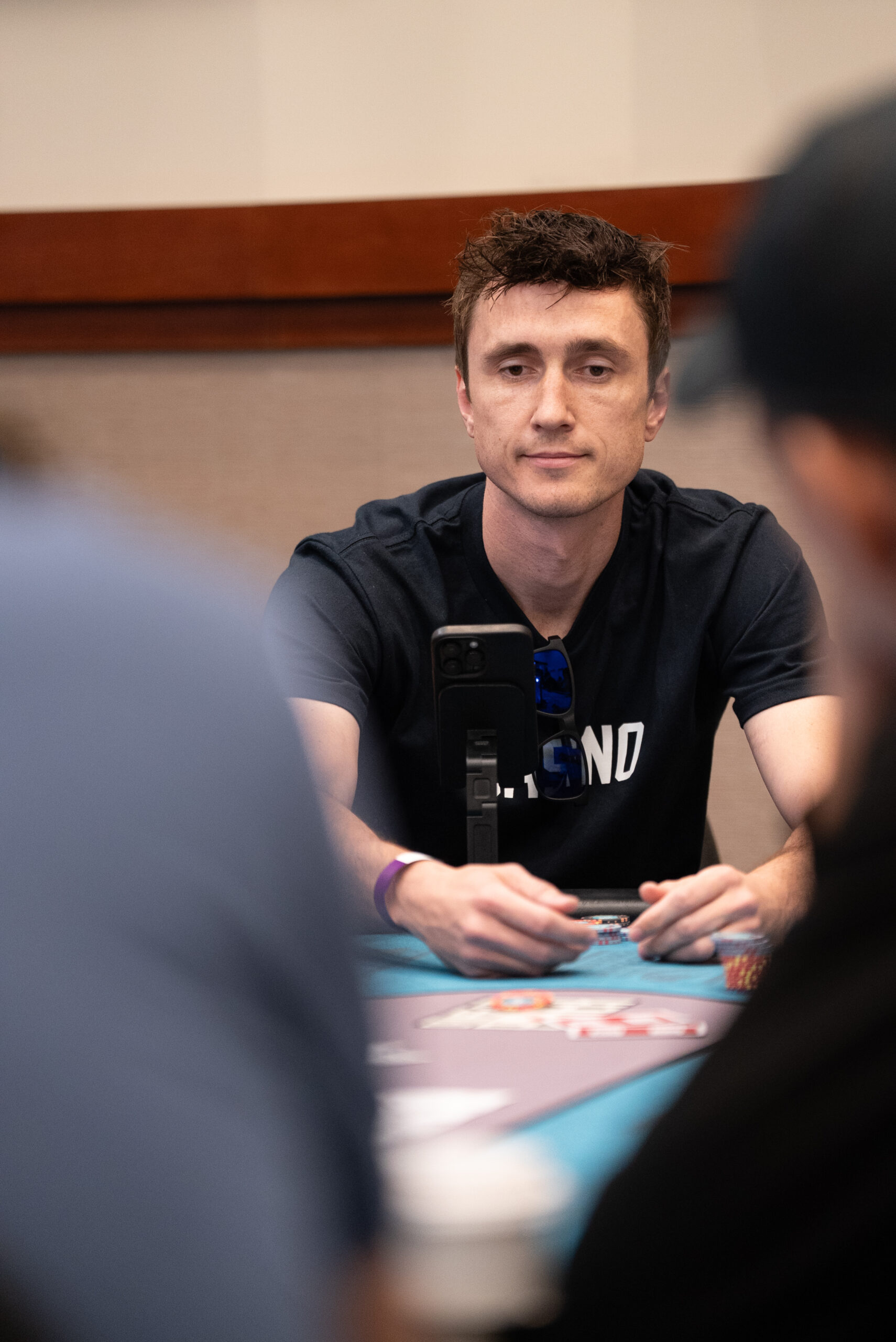 Person focused on poker game.