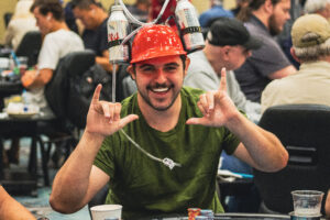 Playing poker with a beer helmet.