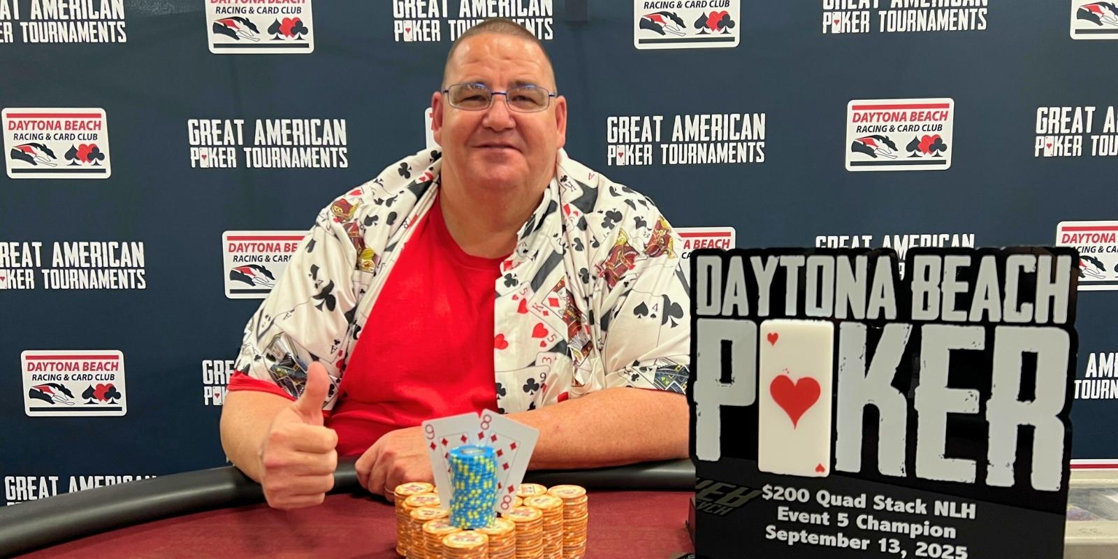 A person sitting at a table with a poker chips and a sign that says daytona beach pokerA person sitting at a table with a poker chips and a sign that says daytona beach poker