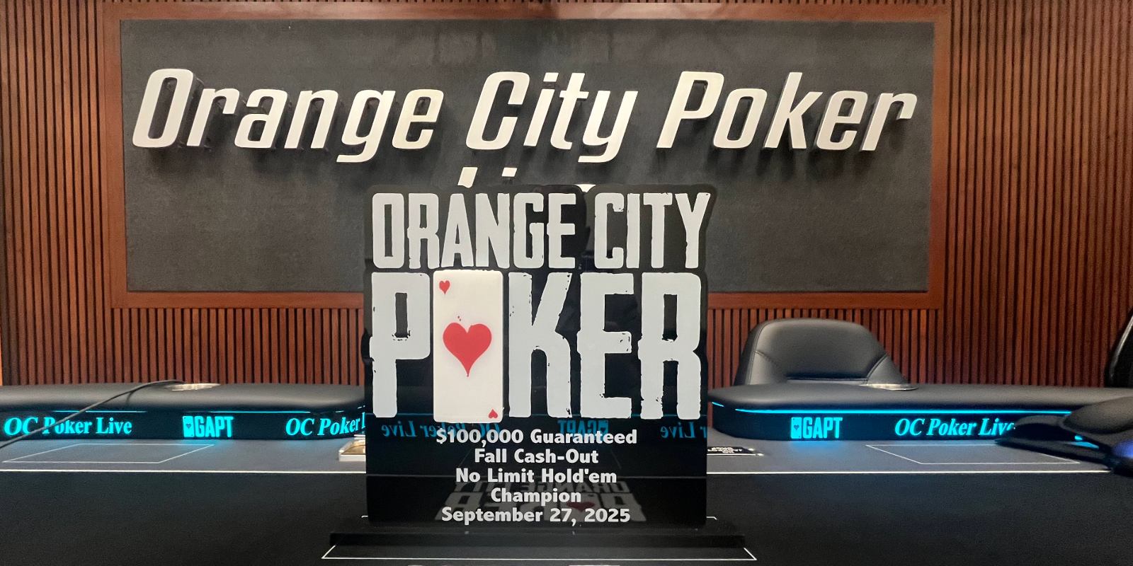 The Orange City Poker Fall Cash-Out trophy sits atop the live stream table, with the Orange City Poker Live sign in the background.