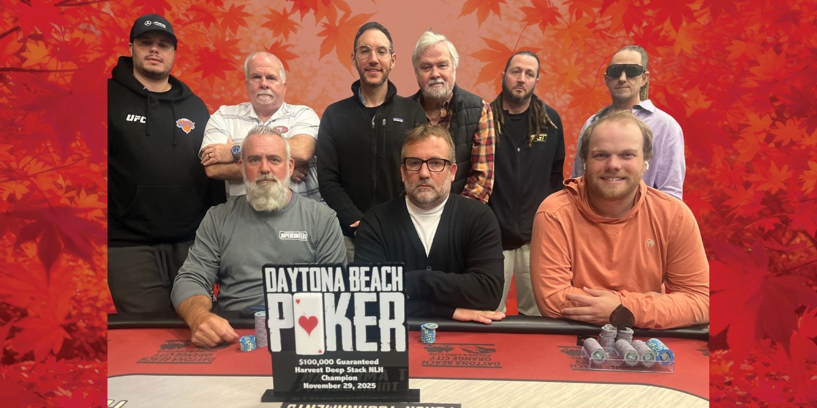 9 poker players pose with the Harvest Deep Stack trophy.