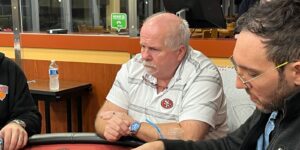 JJ Jensen sits at a poker table.