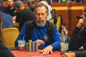 A photo of a bearded poker player sitting with 400,000 in chips.