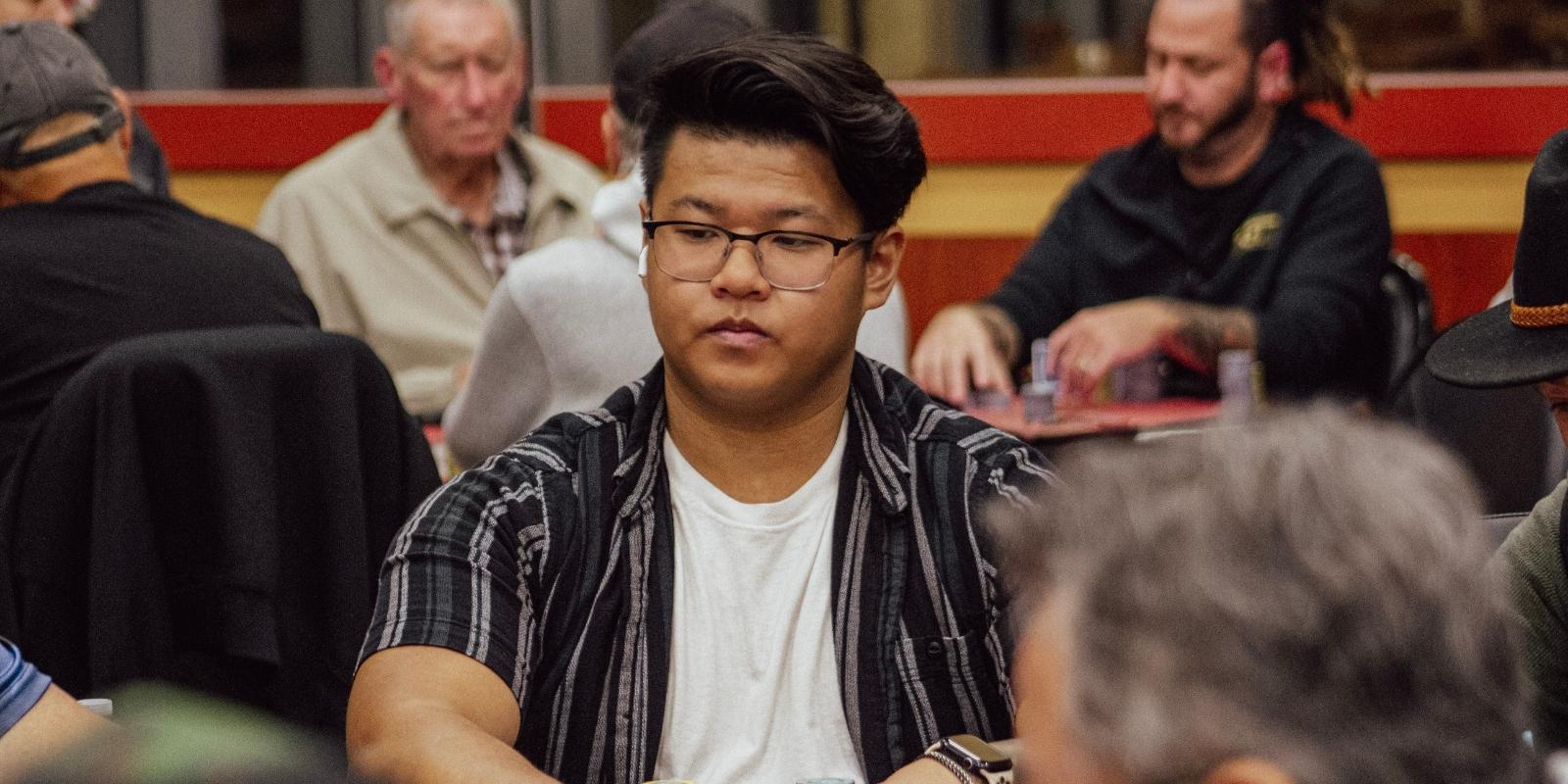 Poker player Kirk Chui waits for his turn to act prior to folding his hand.