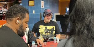 Nathan Lee sits at a poker table in a cat t-shirt.