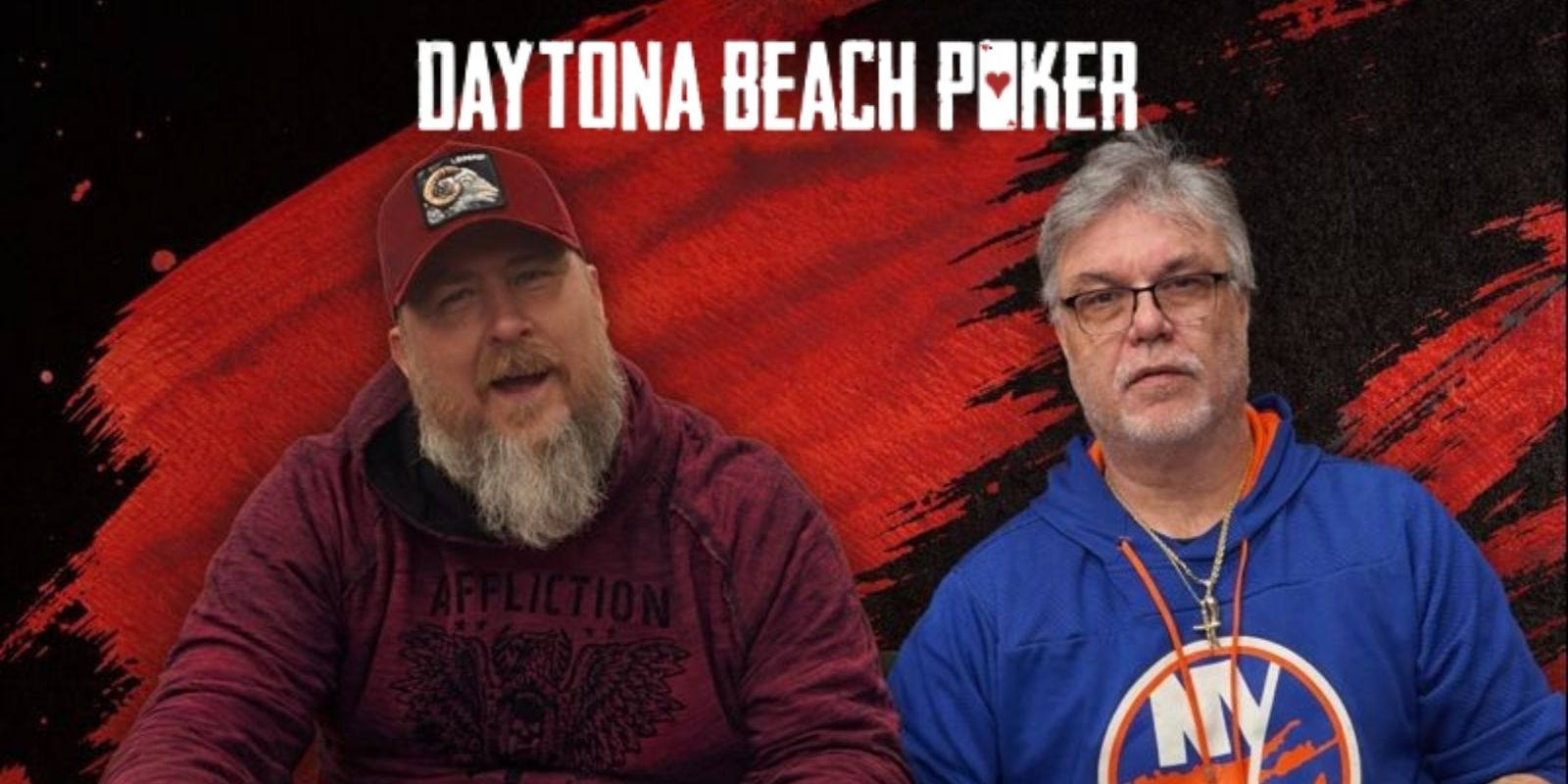 Two people sit at a poker table with stacks of chips in front of them.