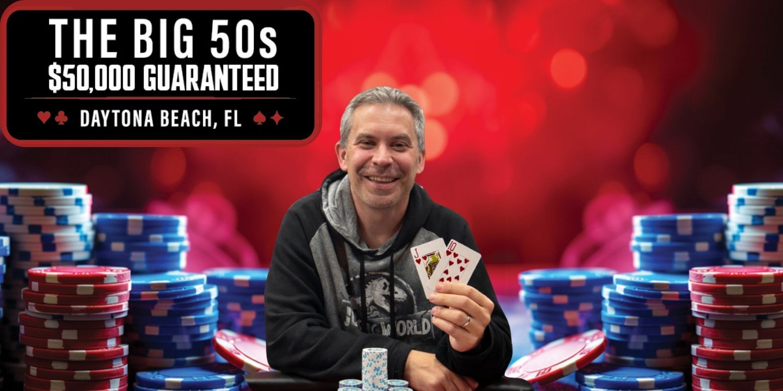 Man holding playing cards, poker chips.