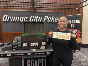 Woman holding cash prize at poker event