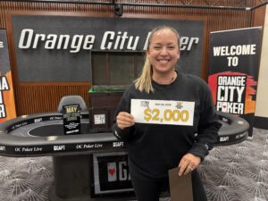 Smiling woman holding $2,000 check