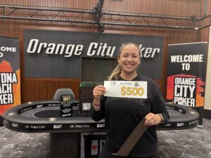 Woman holding $500 poker prize